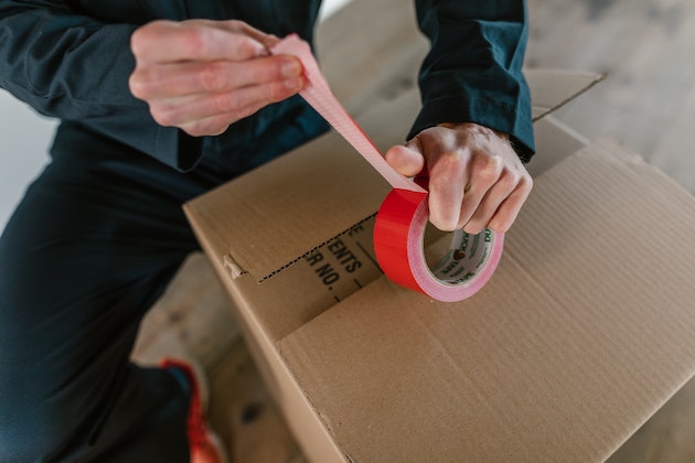 Person Taping a Packing Box