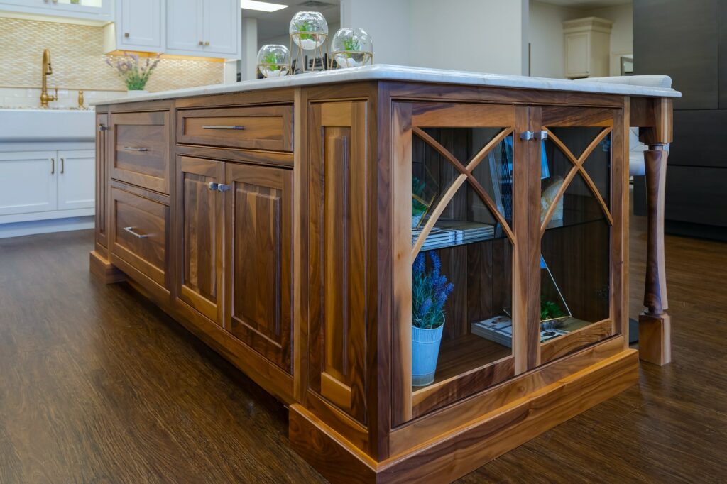 Image of an island with cabinets with glass doors.